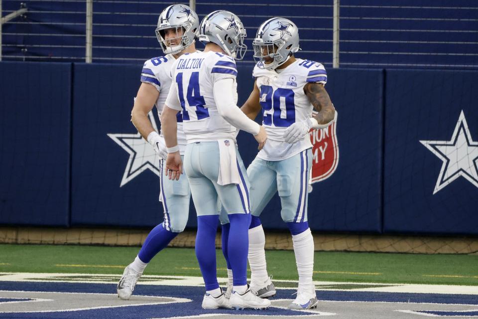 Dallas Cowboys' Andy Dalton (14), Dalton Schultz, rear, celebrate a touchdown run by Tony Pollard (20) in the second half of an NFL football game against the San Francisco 49ers in Arlington, Texas, Sunday, Dec. 20, 2020. (AP Photo/Michael Ainsworth)