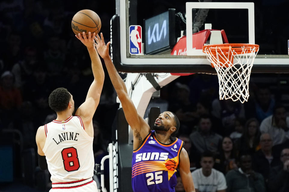 Chicago Bulls guard Zach LaVine (8) shoots over Phoenix Suns forward Mikal Bridges (25) during the first half of an NBA basketball game in Phoenix, Wednesday, Nov. 30, 2022. (AP Photo/Ross D. Franklin)