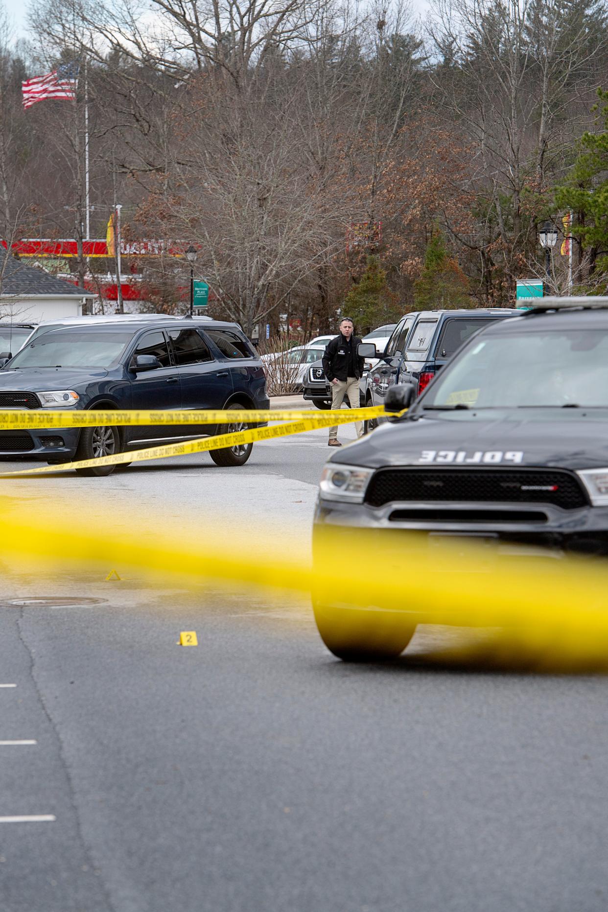 An SBI agent walks near the site of an early morning shooting involving an off-duty Henderson County Sheriff’s deputy, February 23, 2024.