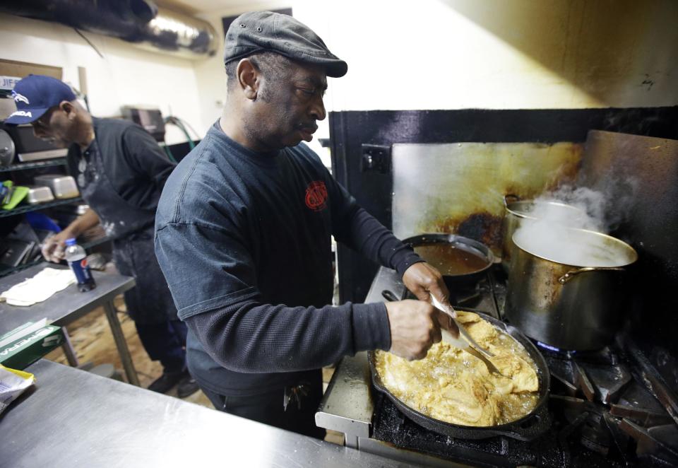 In this Friday, March 22, 2013 photo, Bolton Matthews fries chicken at Bolton's Spicy Chicken and Fish restaurant in Nashville, Tenn. Hot chicken -- fried chicken with varied amounts of seasoning that make the heat level run from mild to extra hot -- is a signature dish of Nashville. (AP Photo/Mark Humphrey)