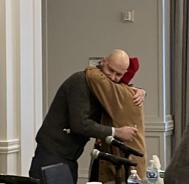 Brian McLain, 41, of Brownstown Twp., hugs his mom after addressing reporters about the child sexual abuse he says he suffered at the hands of a Catholic priest when he was 16. McLain is suing over his ordeal, which he discussed at a press conference on Dec. 19, 2023.