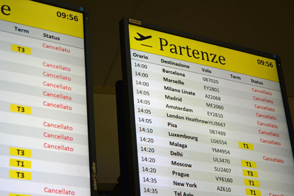 A display board shows various canceled flights from Rome's Leonardo Da Vinci international airport, in Fiumicino, near Rome, Friday, Dec. 13, 2019. As its workers went on nationwide air sector strike on Friday, grounding hundreds of flights, the fate of Italy’s national carrier Alitalia still hangs in the balance. Italy, (Telenews/ANSA via AP)