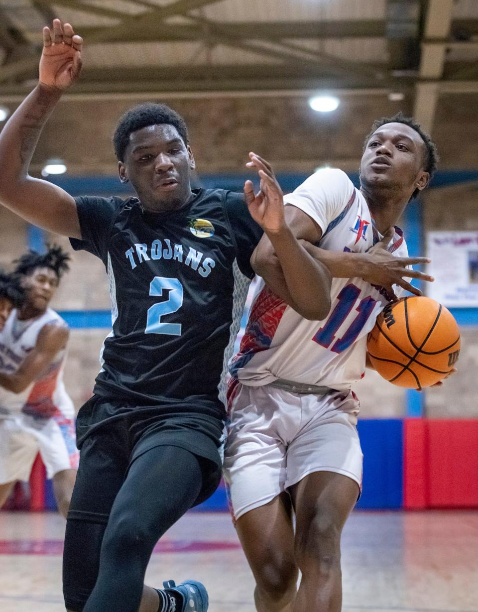 Cachaz Alfred (11) drives past George Woods (2) during the Ribault vs Pine Forest boys Regional Semifinals basketball game at Pine Forest High School in Pensacola on Tuesday, Feb. 22, 2022.