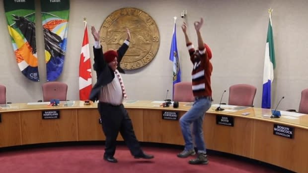 Whitehorse Mayor Dan Curtis receives a bhangra dance lesson from Gurdeep Pandher. Photo from Gurdeep Pandher/Facebook.