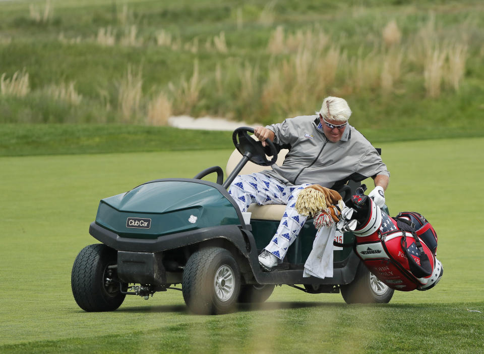 John Daly picks up his bag to pull his putter on the 18th hole during the second round of the PGA Championship golf tournament, Friday, May 17, 2019, at Bethpage Black in Farmingdale, N.Y. (AP Photo/Andres Kudacki)