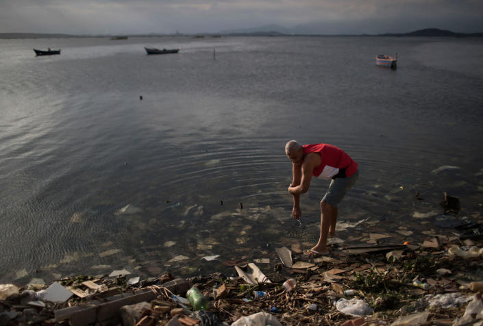 <p>A man washes himself in the polluted waters of Guanabara Bay in Rio de Janeiro, Brazil, Saturday, July 30, 2016. While local authorities including Rio Mayor Eduardo Paes have acknowledged the failure of the city’s water cleanup efforts, calling it a “lost chance” and a “shame,” Olympic officials continue to insist Rio’s waterways will be safe for athletes and visitors. (AP Photo/Felipe Dana)