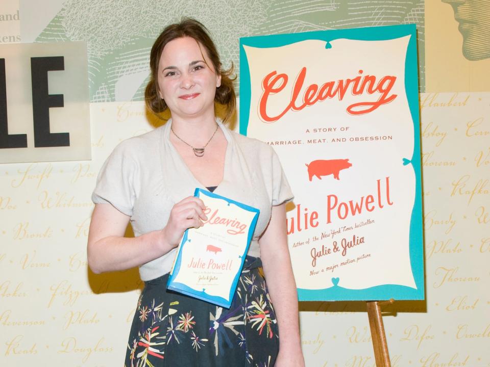 Julie Powell stands in front of a poster of her second book.