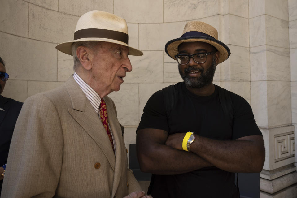 American writer Gay Talese and American poet Reginald Dwayne Betts talk during a reading event in solidarity with Salman Rushdie outside the New York Public Library, Friday, Aug. 19, 2022, in New York. (AP Photo/Yuki Iwamura)
