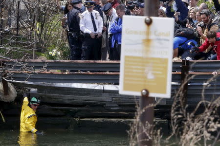 Christopher Swain, a clean-water activist, prepares to enter the Gowanus Canal in the Brooklyn borough of New York April 22, 2015. REUTERS/Shannon Stapleton