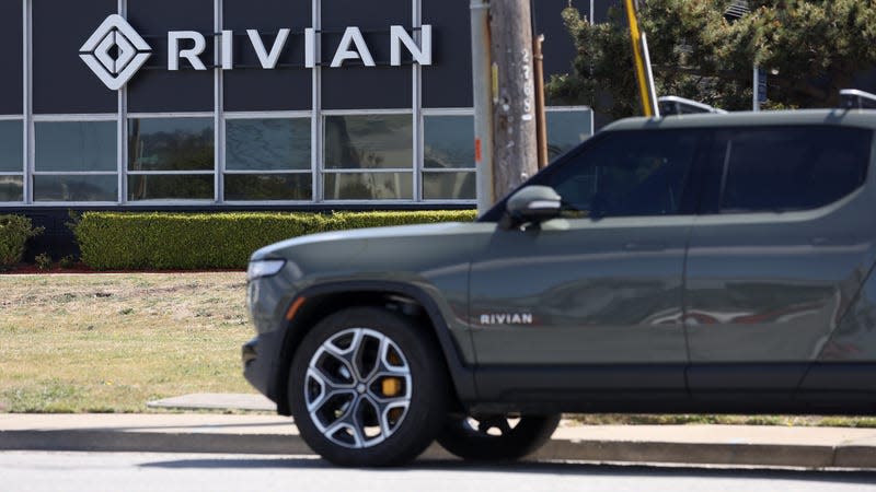 A Rivian electric pickup truck sits in a parking lot at a Rivian service center on May 09, 2022 in South San Francisco, California. 