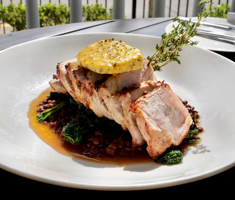 Mustard-crusted pork loin is among the signature entrees offered at La Nouvelle.