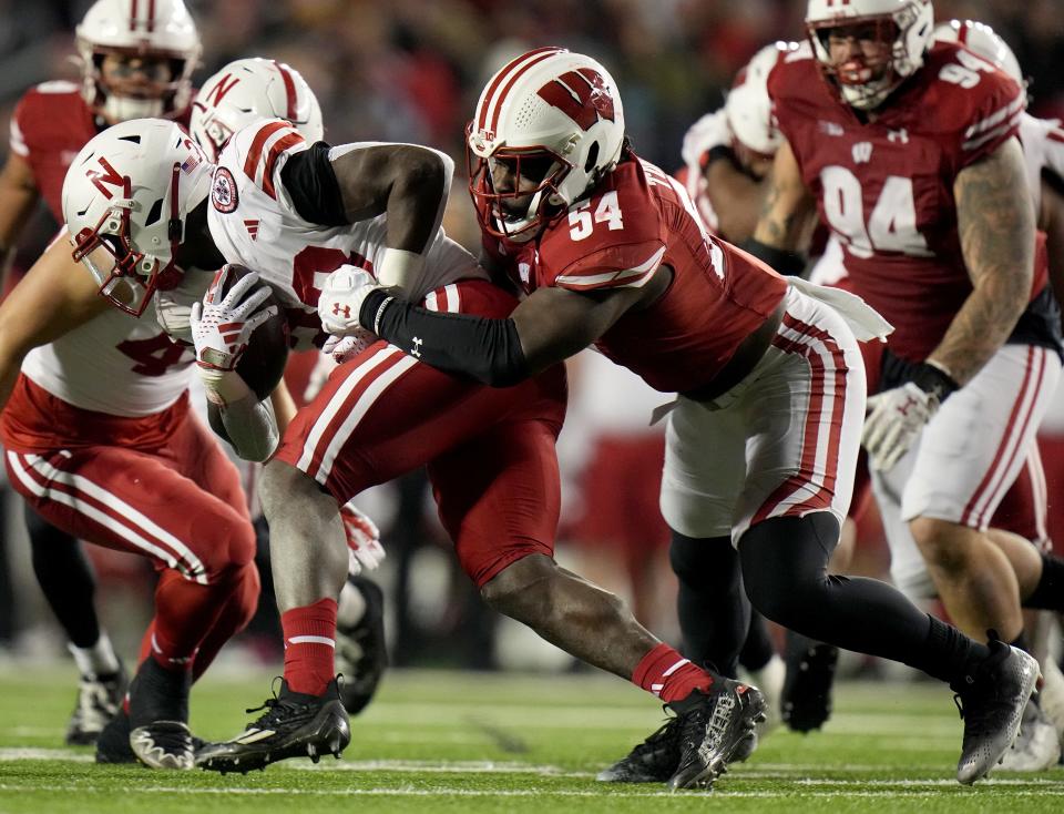 Wisconsin linebacker Jordan Turner (54) tackles Nebraska running back Anthony Grant (23) during the third quarter of their game Saturday, November 18, 2023 at Camp Randall Stadium in Madison, Wisconsin. Wisconsin beat Nebraska 24-17 in overtime.