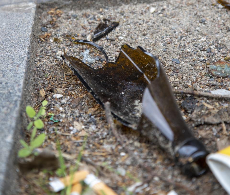 broken glass bottle on an asphalt ground