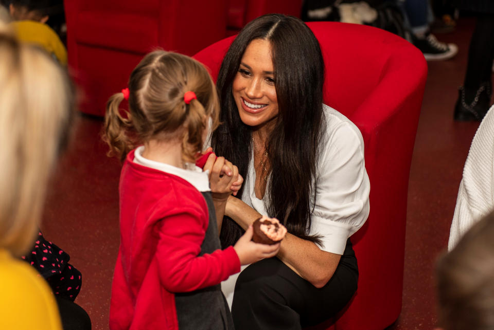 Poppy Dean gives a cake to Britain’s Meghan, Duchess of Sussex during a coffee morning with families of deployed Army personnel at Broom Farm Community Centre in Windsor, Britain November 6, 2019. Picture taken November 6, 2019. Sgt Paul Randall/MoD/Handout via REUTERS  THIS IMAGE HAS BEEN SUPPLIED BY A THIRD PARTY.