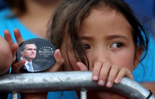 A young supporter of Republican presidential candidate Mitt Romney holds a campaign button during a campaign rally in Norfolk, Virginia