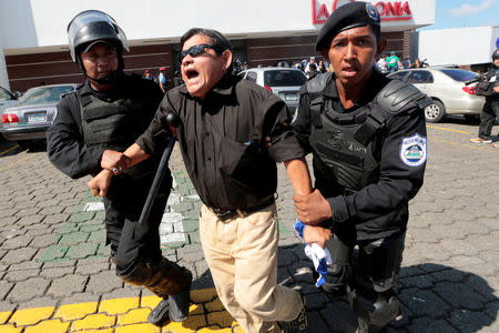 Riot police detain a protester during a march called " United for freedom" against Nicaraguan President Daniel Ortega in Managua, Nicaragua October 14, 2018. REUTERS/Oswaldo Rivas