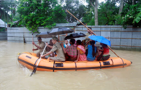 Members of Tripura State Rifles (TSR) evacuate people from a flooded area after heavy rains in Baldakhal village on the outskirts of Agartala, India August 12, 2017. REUTERS/Jayanta Dey