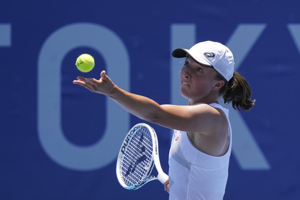 Iga Swiatek, of Poland, serves to Mona Barthel, of Germany, during the tennis competition at the 2020 Summer Olympics, Saturday, July 24, 2021, in Tokyo. (AP Photo/Patrick Semansky)