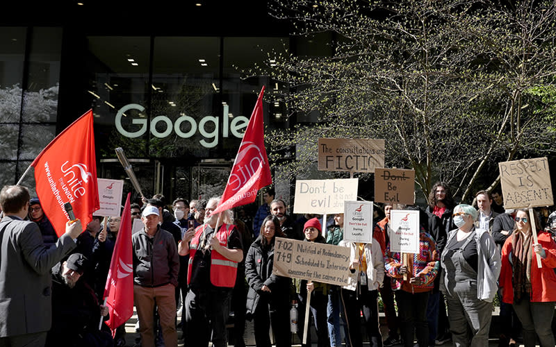 Google employees hold signs during a protest outside Google headquarters in London