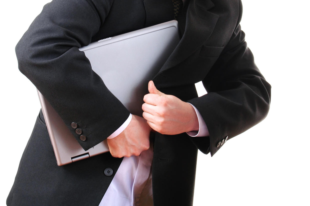 A man stealing a laptop. (PHOTO: Getty Images)