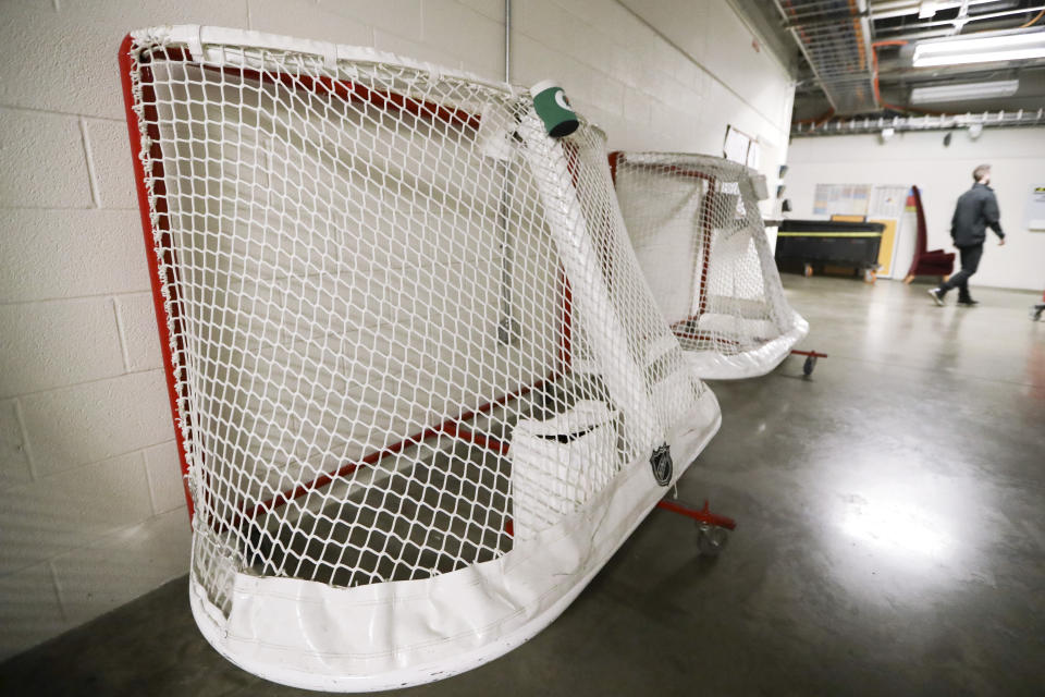 FILE - In this March 12, 2020, file photo, goals used by the NHL hockey club Nashville Predators are stored in a hallway in Bridgestone Arena in Nashville, Tenn. Time is running short for the NHL to start its season on Jan. 1. Various pandemic-related geographic and economic issues remain unresolved. (AP Photo/Mark Humphrey)