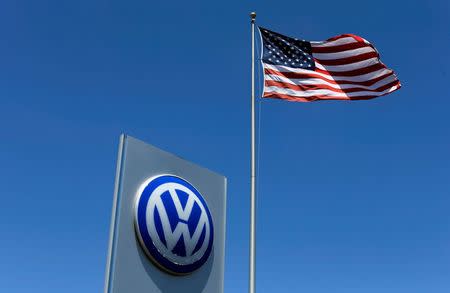 A U.S. flag flutters in the wind above a Volkswagen dealership in Carlsbad, California, U.S. May 2, 2016. REUTERS/Mike Blake/File Photo