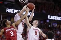 Wisconsin's Nate Reuvers, center, and Tyler Wahl (5) go after a defensive rebound against Indiana's Justin Smith (3) during the first half of an NCAA college basketball game Saturday, Dec. 7, 2019, in Madison, Wis. (AP Photo/Andy Manis)