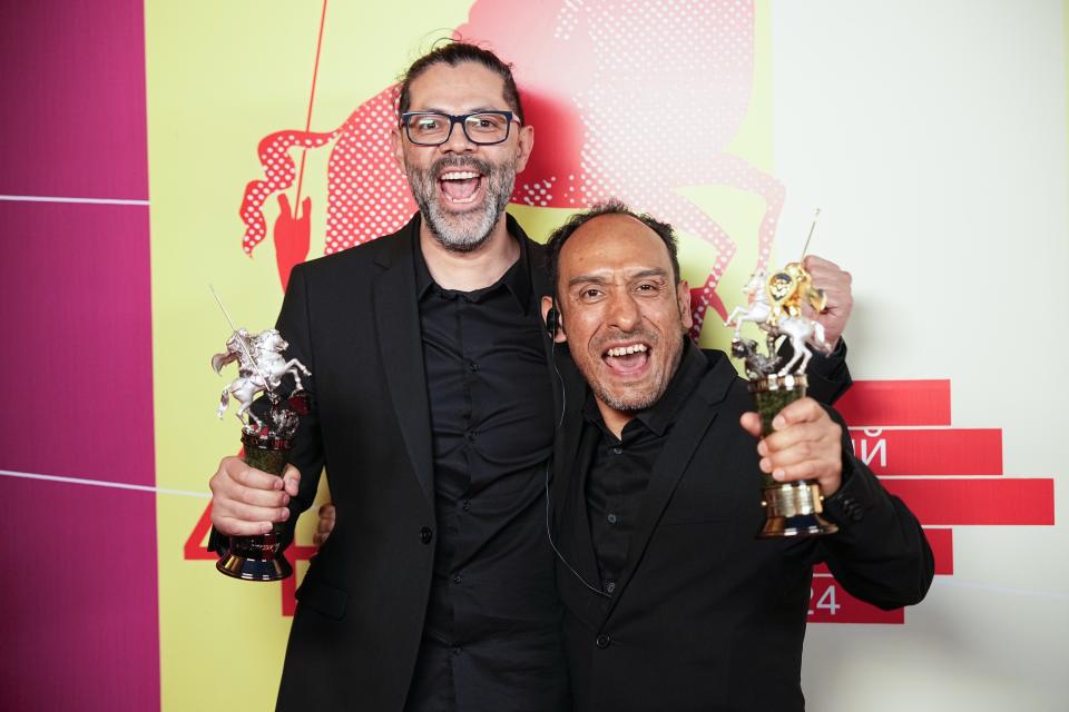 Mexican director Miguel Salgado, right, and Alfredo Mendoza, actor and screenwriter, pose with their trophy for a photo after the closing ceremony of the 46th Moscow International Film Festival in Moscow, Russia, on Friday, April 26, 2024. A Mexican film has won the top prize at the Moscow International Film Festival which took place as major Western studios boycott the Russian market and as Russia's war in Ukraine grinds into its third year. "Shame," a film by director Miguel Salgado and co-produced by Mexico and Qatar, was the most highly awarded film at the festival which began in 1935 and which has been held annually since 1999. (AP Photo/Alexander Zemlianichenko)