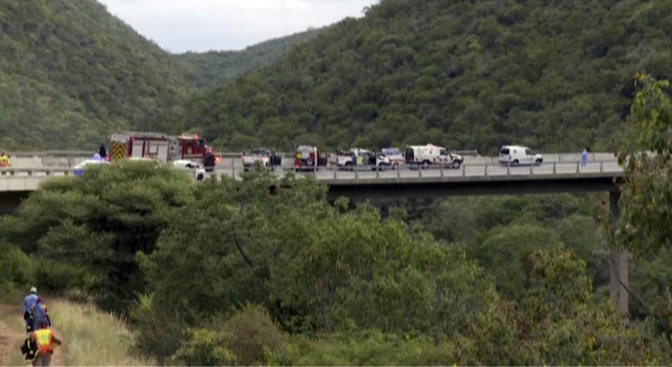 In this image taken from video provided by eNCA, a bus carrying worshippers headed to an Easter festival plunged off a bridge on a mountain pass and burst into flames in Limpopo, South Africa, on Thursday, March 28, 2024, killing multiple people, authorities said. (eNCA via AP)