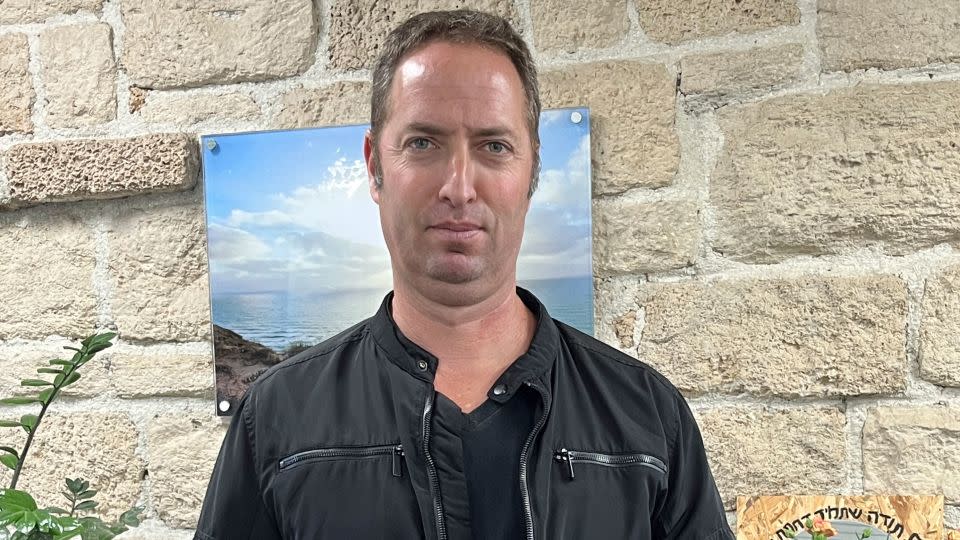 Amos Gofer, CEO of the Kfar Silver youth village, poses with the gnarled remnants of a Hamas rocket which landed near to the school. - courtesy Monique Zahavi