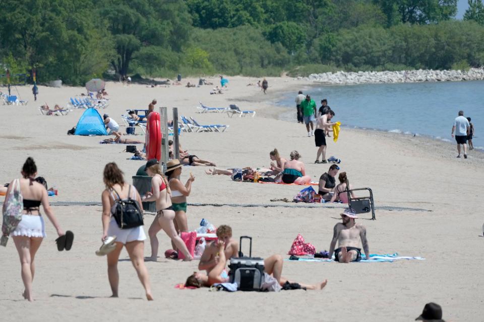 Beachgoers relax and sunbathe at Bradford Beach on North Lincoln Memorial Drive in Milwaukee on Thursday. While lifeguard recruitment is up for Milwaukee County, there will not be enough to staff Lake Michigan beaches.