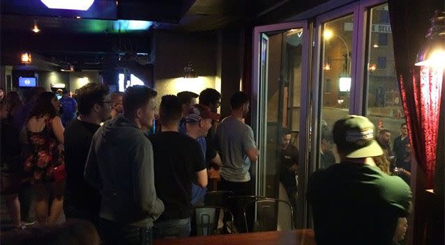 People at the bar watch on during the arrest. Photo: Twitter/ @IAmByks