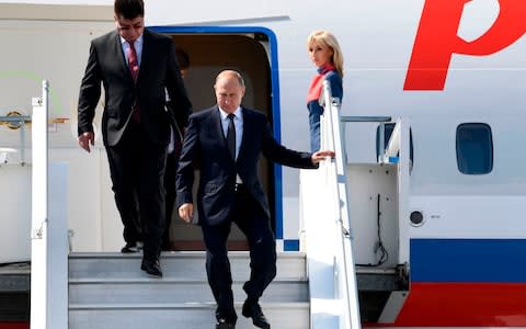 Vladimir Putin and Russia's new ambassador to Finland Pavel Kuznetsov disembark from a plane at Helsinki-Vantaa Airport in Helsinki - Credit: Jonathan Nackstrand/AFP