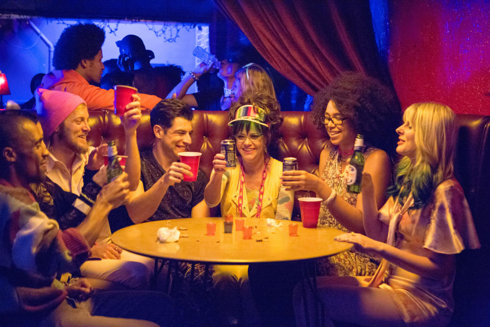 A group of people sitting around a table at a bar