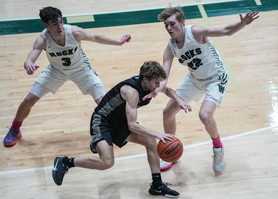 Brownsburg Bulldogs guard Drew Thompson (4) rushes up the court against Westfield Shamrocks guard Caleb Wise (22) and Westfield Shamrocks guard Trey Buchanan (3) on Friday, Jan. 20, 2023 at Westfield High School in Westfield. The Brownsburg Bulldogs defeated the Westfield Shamrocks, 62-51. 