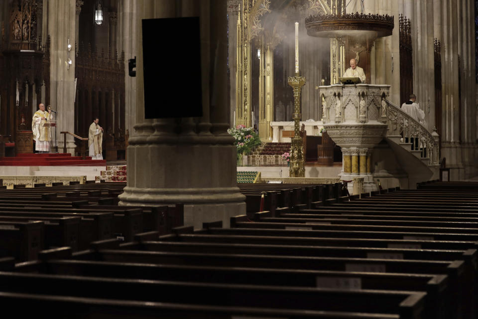 Easter Mass is conducted without congregants at St. Patrick's Cathedral in New York, Sunday, April 12, 2020. Due to coronavirus concerns, no congregants were allowed to attend the Mass but it was broadcast live on a local TV station. (AP Photo/Seth Wenig)