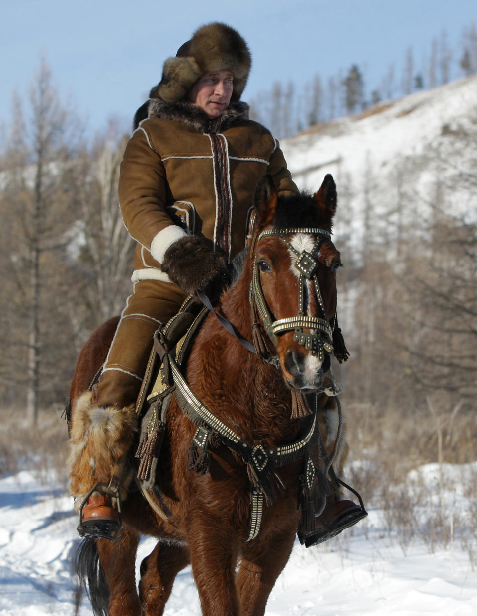 Putin rides a horse in the Karatash foothills in Siberia, Russia, on Feb. 25, 2010.