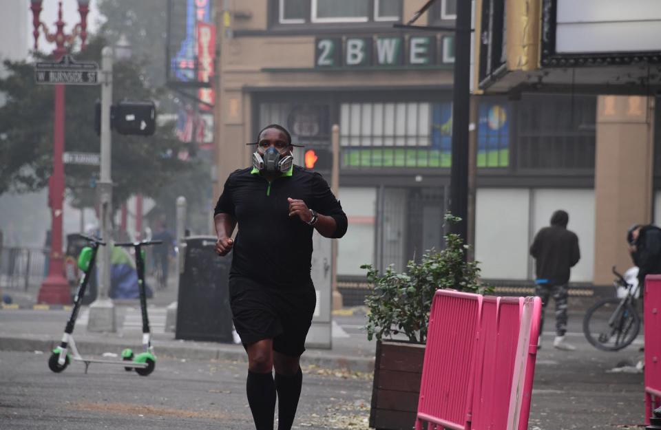 <span class="caption">A runner wears a respirator on a smoky day in Portland, Oregon, in 2020.</span> <span class="attribution"><a class="link " href="https://www.gettyimages.com/detail/news-photo/local-resident-wears-a-respirator-as-he-jogs-in-downtown-news-photo/1228516107" rel="nofollow noopener" target="_blank" data-ylk="slk:Robyn Beck/AFP via Getty Images;elm:context_link;itc:0;sec:content-canvas">Robyn Beck/AFP via Getty Images</a></span>