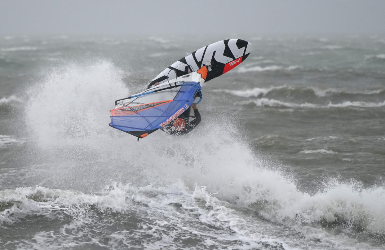 A wind surfer surfs a wave as they take to the sea during high winds in Bracklesham Bay, West Sussex, following on from Storm Eunice. More wet and windy weather is set to sweep the UK on Sunday as Storm Franklin is set to strike the UK just days after Storm Eunice destroyed buildings and left 1.4 million homes without power. Picture date: Sunday February 20, 2022.