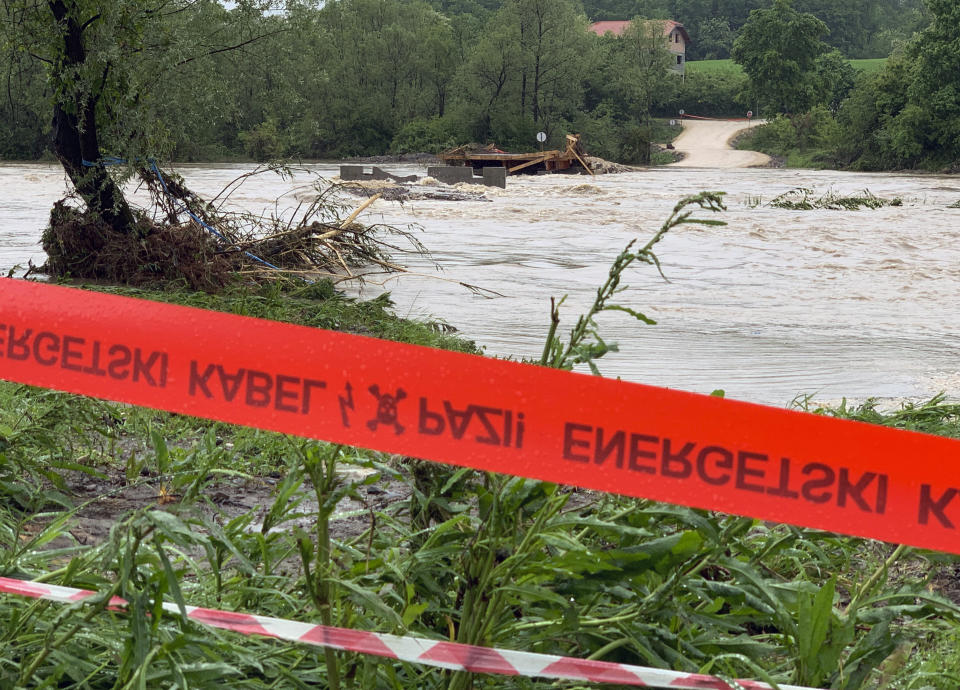 This photo shows a destroyed bridge near the village Tesanjka, Bosnia, Tuesday, May 14, 2019. Overflowing rivers in Bosnia and Croatia have flooded dozens of homes and roads, putting the Balkans on high alert after 2014 floods killed dozens of people died and submerged large areas of the region. (AP Photo/Eldar Emric)