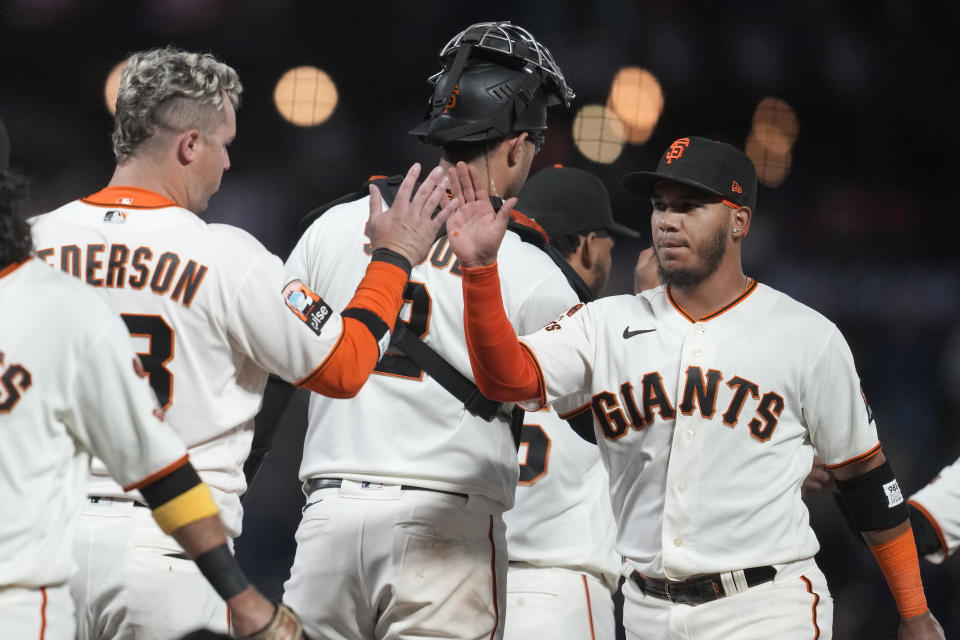 San Francisco Giants' Joc Pederson, left, and Thairo Estrada, right, celebrate after the Giants defeated the Colorado Rockies in a baseball game in San Francisco, Sunday, Sept. 10, 2023. (AP Photo/Jeff Chiu)