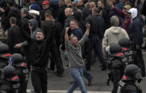 Men shout during a far-right protest in Chemnitz, Germany, Monday, Aug. 27, 2018 after a man has died and two others were injured in an altercation between several people of "various nationalities" in the eastern German city of Chemnitz on Sunday. (AP Photo/Jens Meyer)