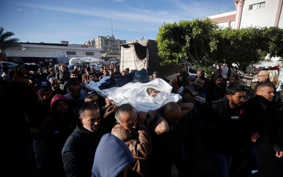 Palestinians carry the body of Samer Abu Daqqa