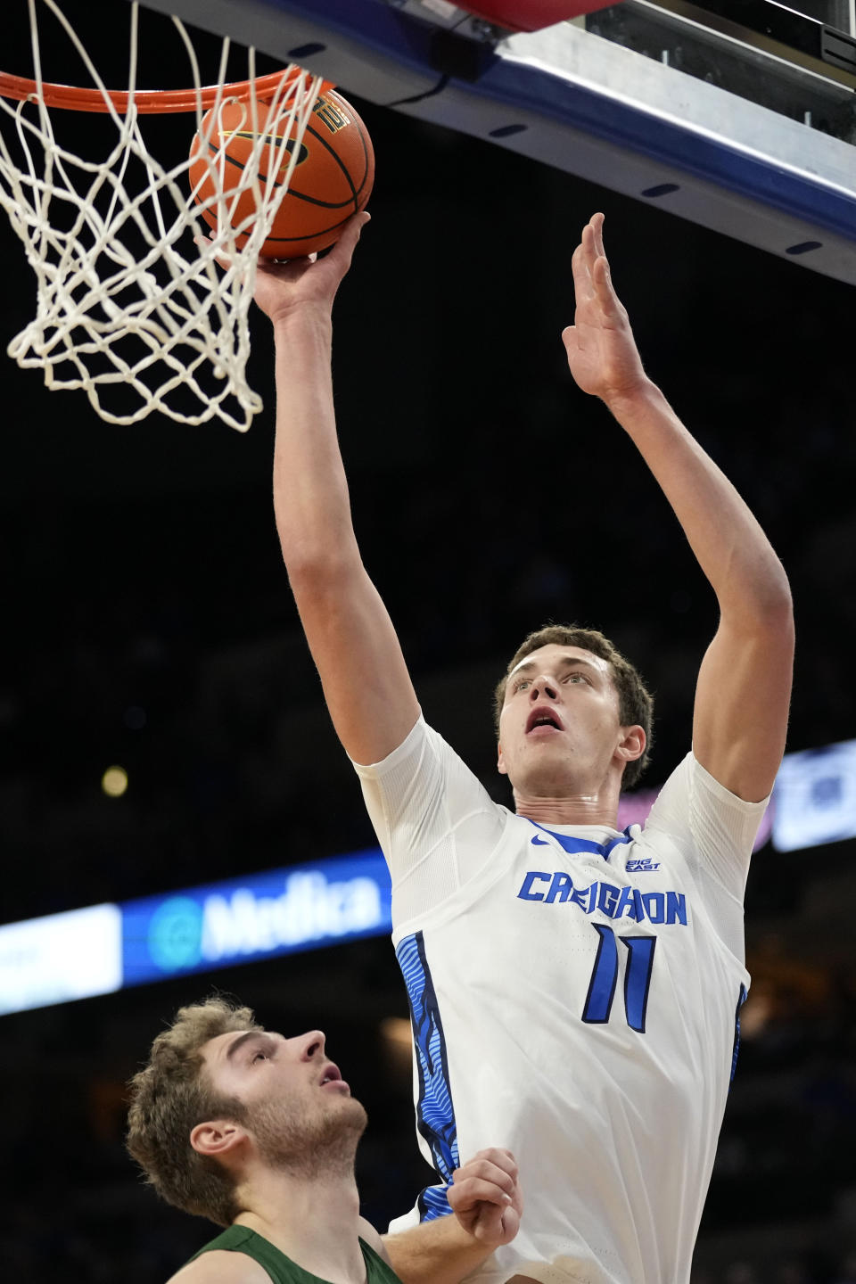 Creighton center Ryan Kalkbrenner (11) shoots over North Dakota State forward Joshua Streit during the first half of an NCAA college basketball game, Saturday, Nov. 11, 2023, in Omaha, Neb. (AP Photo/Charlie Neibergall)