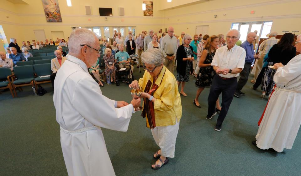 Members of SanibelÕs St. Michael & All Angels Church gather during Palm Sunday on April 2, 2023, at Fort Myers' Peace Lutheran Church. The congregation has had to conduct services at a different location after their Sanibel building was badly damaged by Hurricane Ian last year.