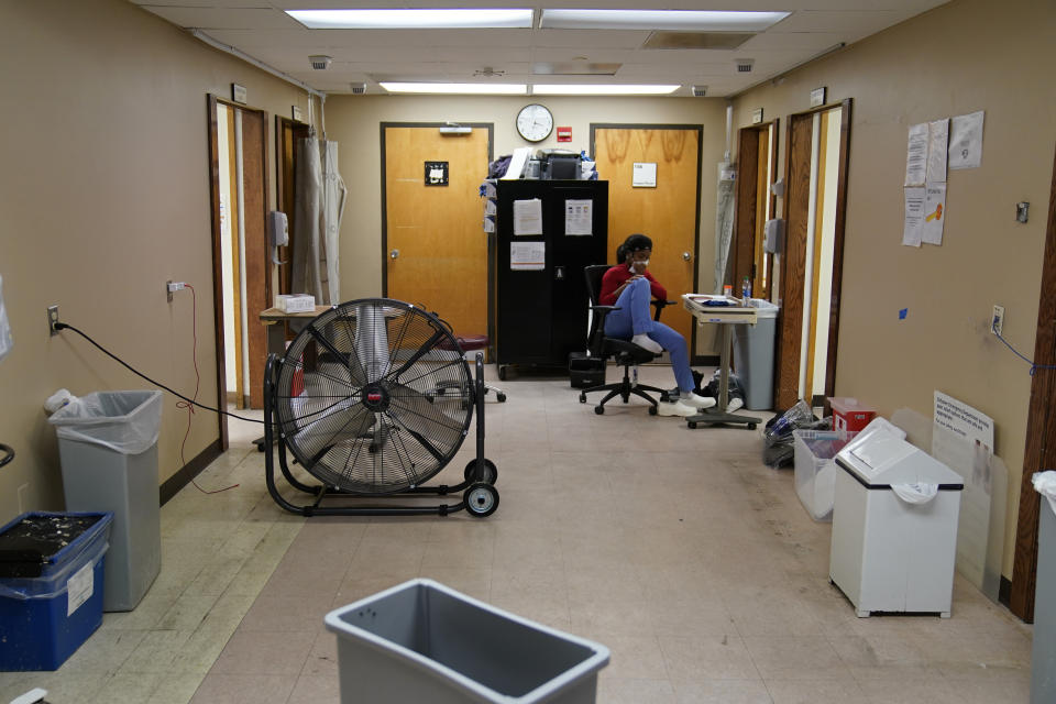 A healthcare worker sits in a hurricane damaged emergency room at Leonard J. Chabert Medical Center in the aftermath of Hurricane Ida, Friday, Sept. 3, 2021, in Houma, La. The emergency room had recently reopened after the hospital evacuated patients and had to close due to the hurricane. (AP Photo/John Locher)