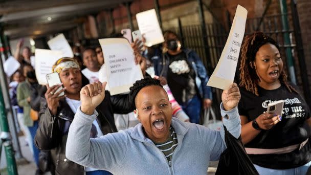 PHOTO: Parents and community members chant as they march around P.S. 189 to protest New York City Mayor Eric Adams' plan to temporarily house immigrants in the school's gymnasium, May 16, 2023, in New York. (John Minchillo/AP)