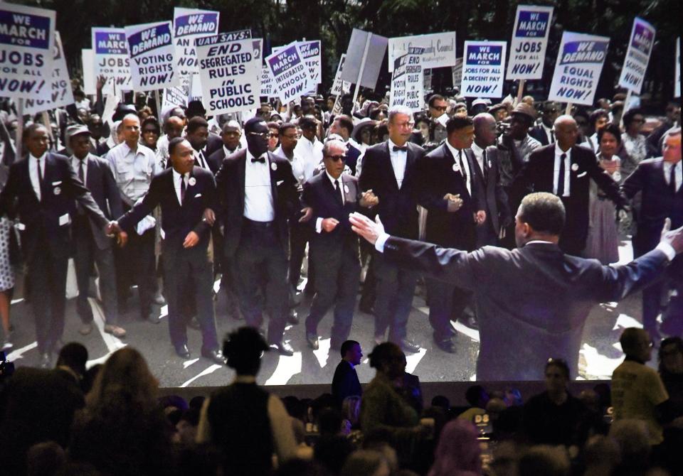 As participants found their seats at Friday's annual Martin Luther King Jr. Breakfast, vintage images from the 1960s' civil rights movement were shown on the screen.