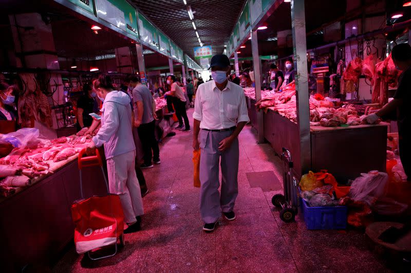 Customer wearing a face mask shops at pork meat hall inside the Yuegezhuang wholesale market, following new cases of coronavirus disease (COVID-19) infections in Beijing