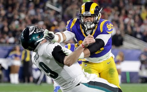 Los Angeles Rams defensive end Aaron Donald hits Philadelphia Eagles quarterback Nick Foles after Foles threw the ball away during the first half in an NFL football game in Los Angeles. The Rams know they've got to pressure Tom Brady early and often to have a chance in the Super Bowl, and they've been assembling the tools for this job all year long. They signed Ndamukong Suh to a big free-agent deal, wrote a record-breaking contract for Aaron Donald and acquired edge rusher Dante Fowler from Jacksonville down the stretch - Credit: AP